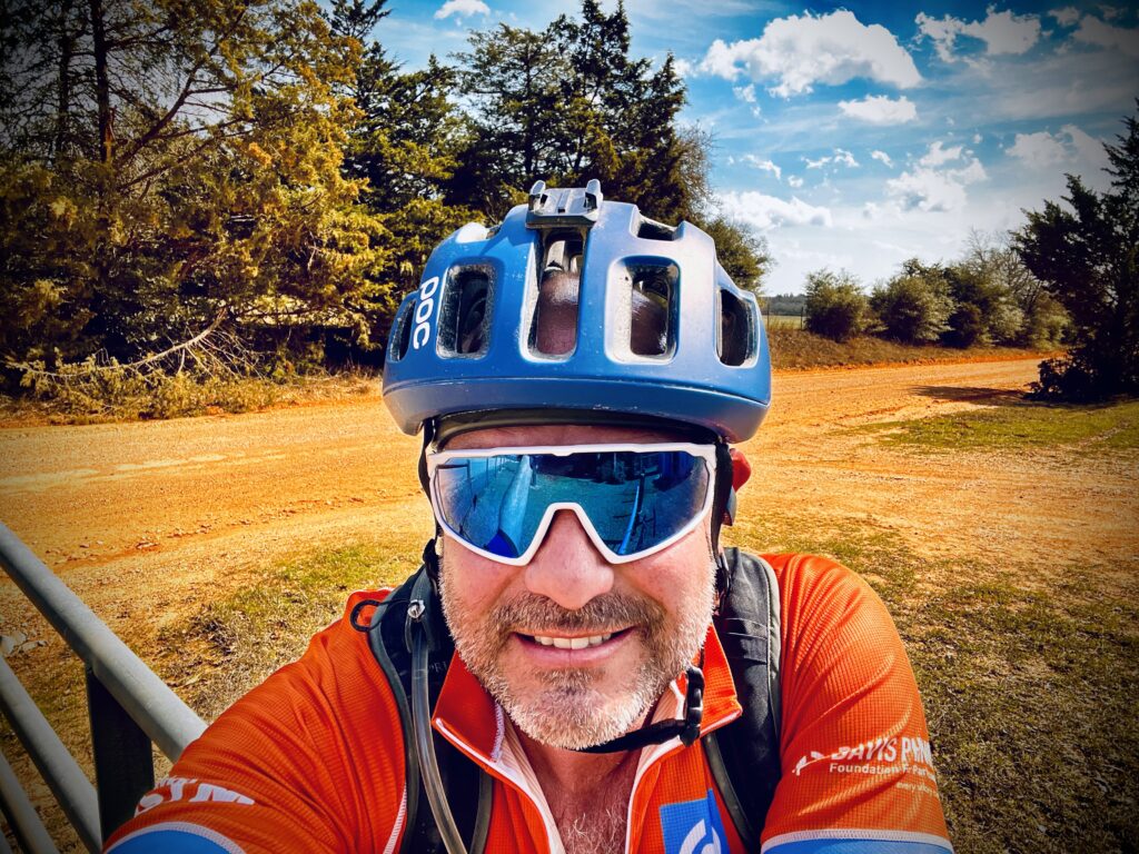 Chad Everett Harris riding his gravel bike in rural Texas.